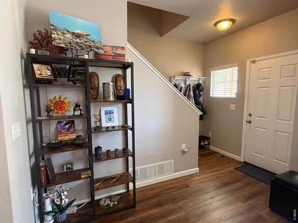 a living room with furniture wooden floor and a window