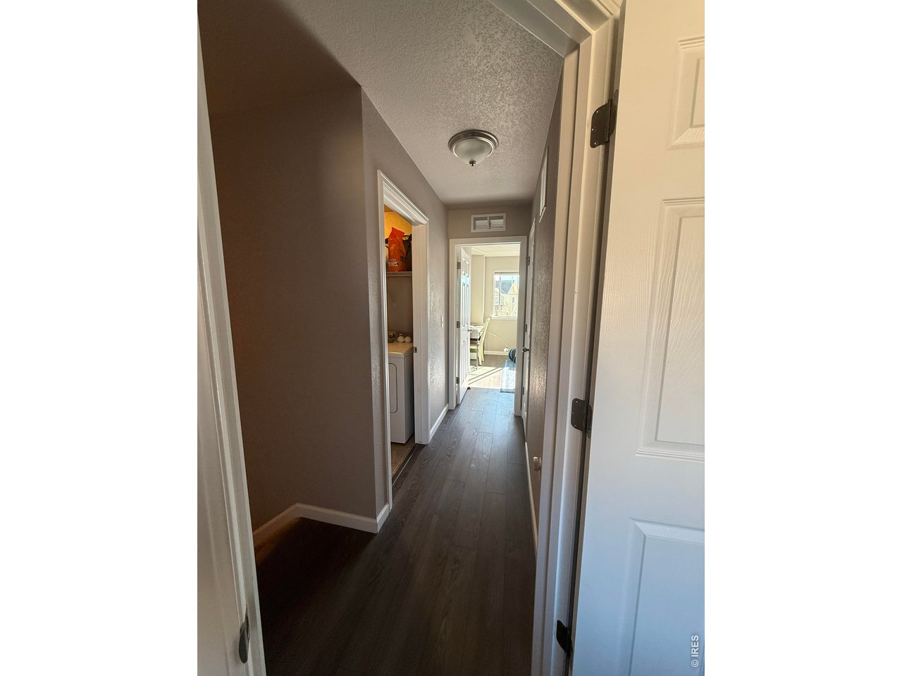 810 Gentlewind Way Berthoud, CO 80513 - Photo 19 of 35 view from primary bedroom down hall to second bedroom