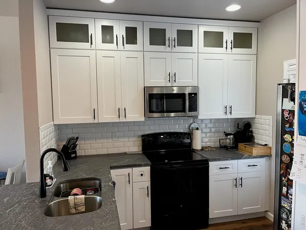 a kitchen with sink cabinets and microwave