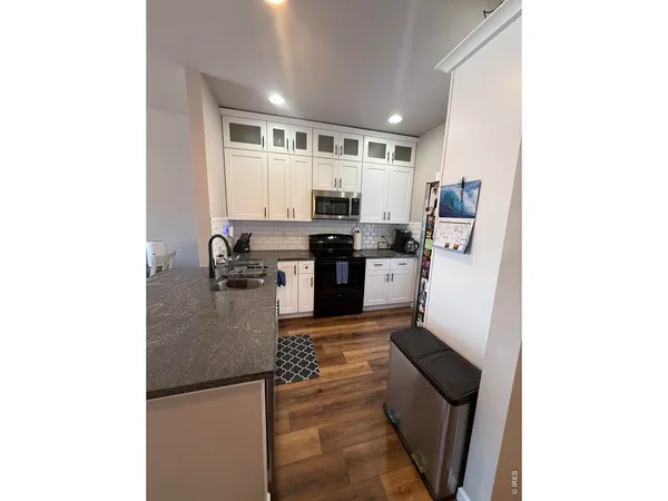 a kitchen with stainless steel appliances granite countertop a sink and cabinets