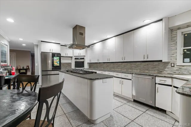a kitchen with stainless steel appliances granite countertop sink stove top oven and cabinets