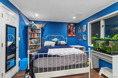 a bedroom with furniture and a book shelf