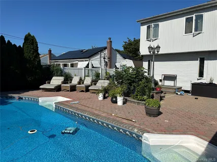 a view of a house with sitting area and garden