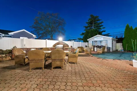 a roof deck with table and chairs under an umbrella