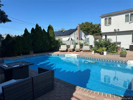 a view of a house with yard and sitting area