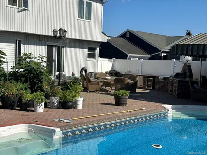 a view of a house with backyard and sitting area