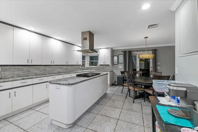 a kitchen with a sink and a stove top oven