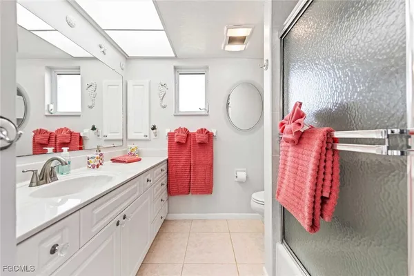 a bathroom with a sink vanity and mirror