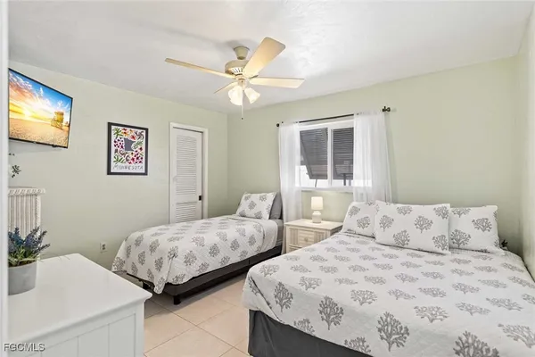 a bedroom with two beds and painting on the wall
