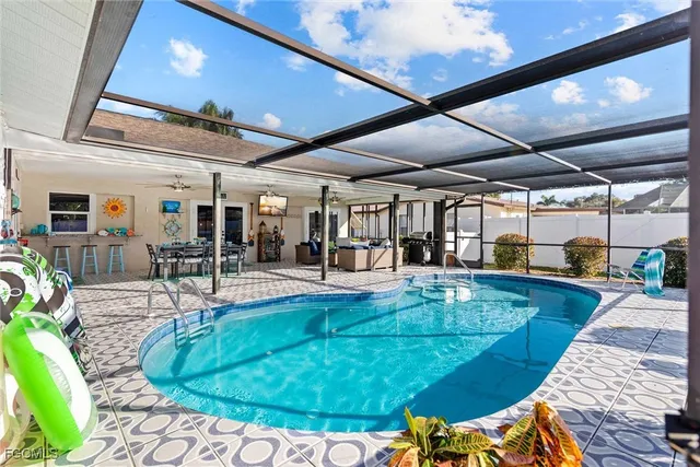 a view of a swimming pool with outdoor seating