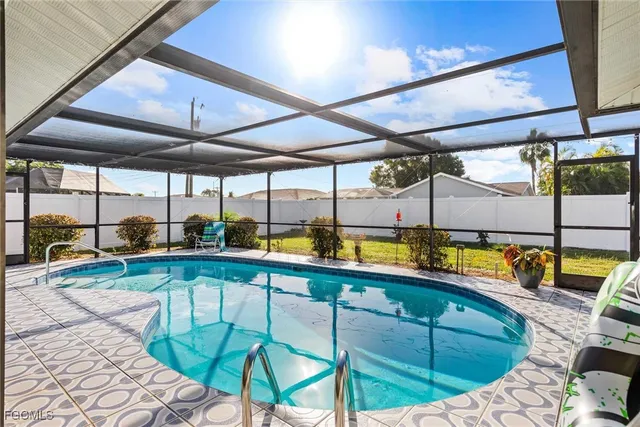 a view of swimming pool with chairs in front of it