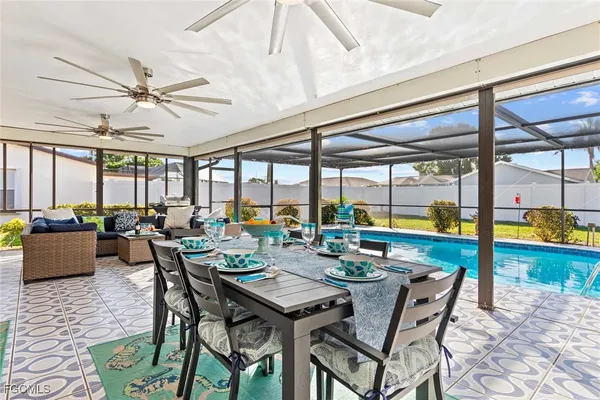 a view of a dining room with furniture large windows and wooden floor