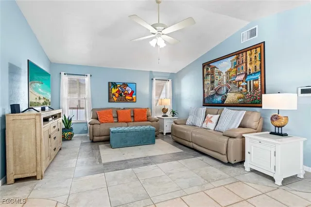 a living room with furniture and a baby crib