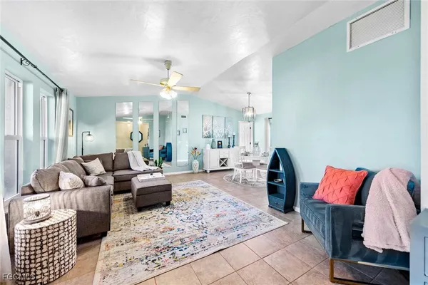 a living room with furniture rug and a chandelier