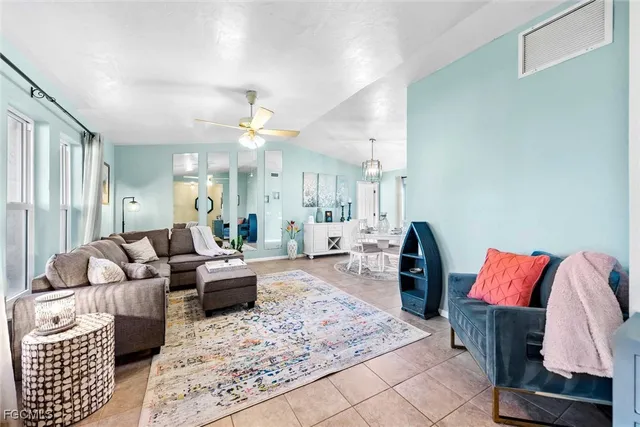 a living room with furniture rug and a chandelier