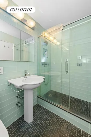 a bathroom with a sink toilet and shower