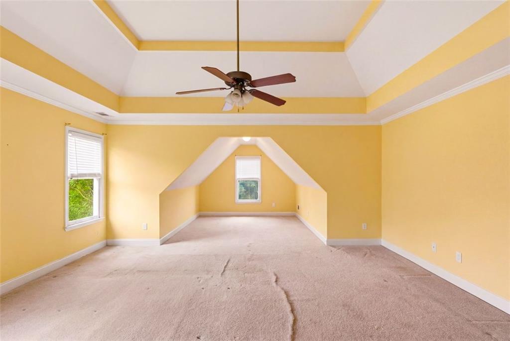 3420 Bulloch Lake Road Loganville, GA 30052 - Photo 35 of 57 a view of a big room with a ceiling fan and windows