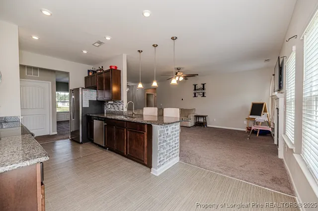 a large kitchen with a sink and cabinets