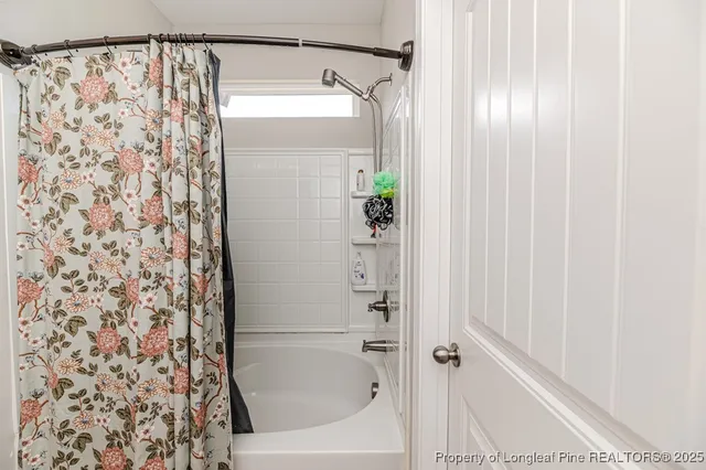 a bathroom with a shower curtain and a shower curtain