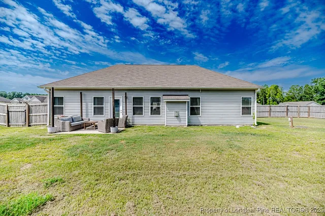 a backyard of a house with table and chairs