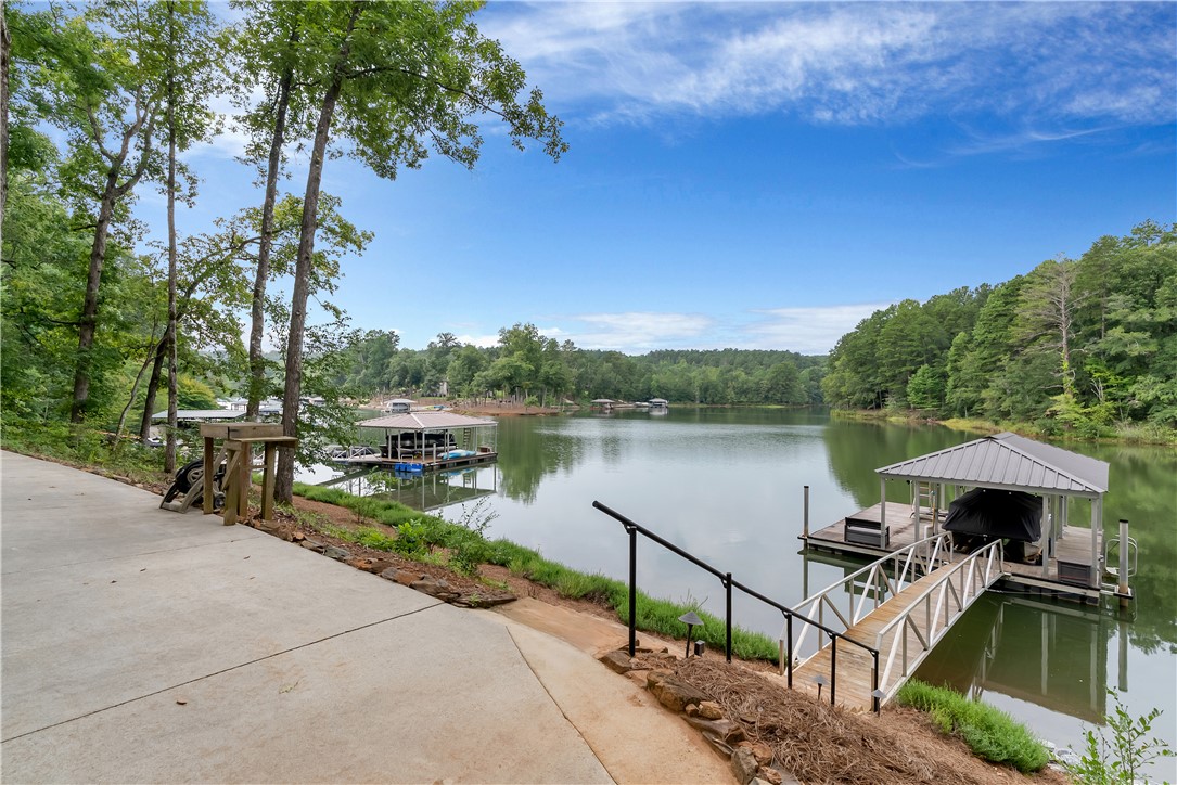 329 High Hampton Road Salem, SC 29676 - Photo 28 of 47 A concrete pathway leads down to a private covered boat dock on peaceful waters.