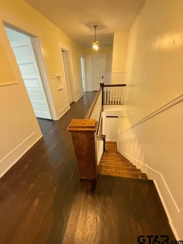a view of a room with wooden floor