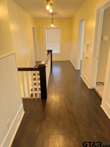 a view of a room with wooden floor
