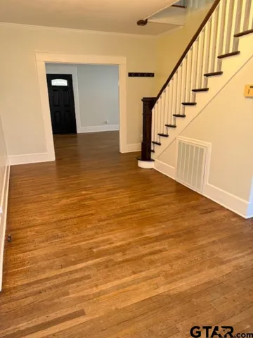 a view of a room with wooden floor and stairs