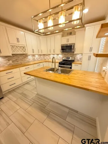 a kitchen with stainless steel appliances a sink and cabinets
