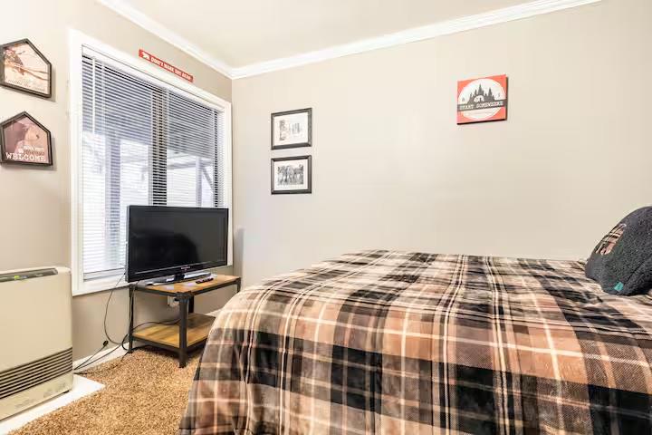 33840 Upper Leland Road, Unit B Pinecrest, CA 95364 - Photo 14 of 35 a bedroom with a bed and flat screen tv