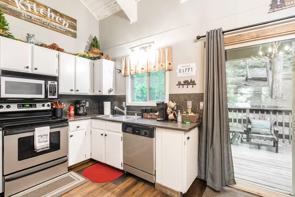 33840 Upper Leland Road, Unit B Pinecrest, CA 95364 - Photo 5 of 35 a kitchen with a stove a sink and a microwave