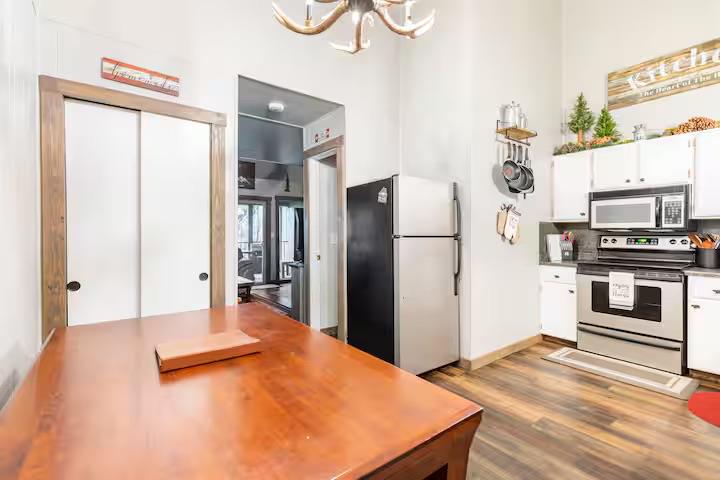 33840 Upper Leland Road, Unit B Pinecrest, CA 95364 - Photo 6 of 35 a view of a kitchen with refrigerator and wooden floor