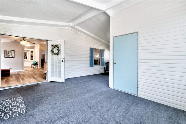 a view of a chair and table in the back yard of the house
