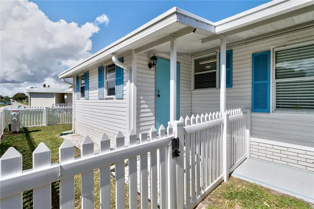a view of house with a large window and sitting area