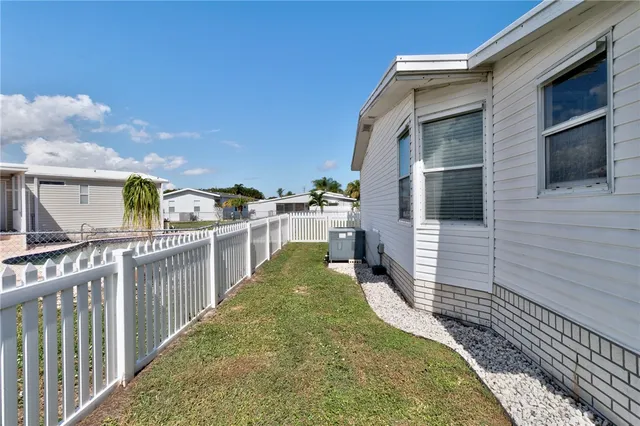 a balcony with couches and a potted plant on the table