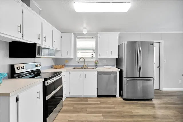 a view of kitchen with cabinets and wooden floor