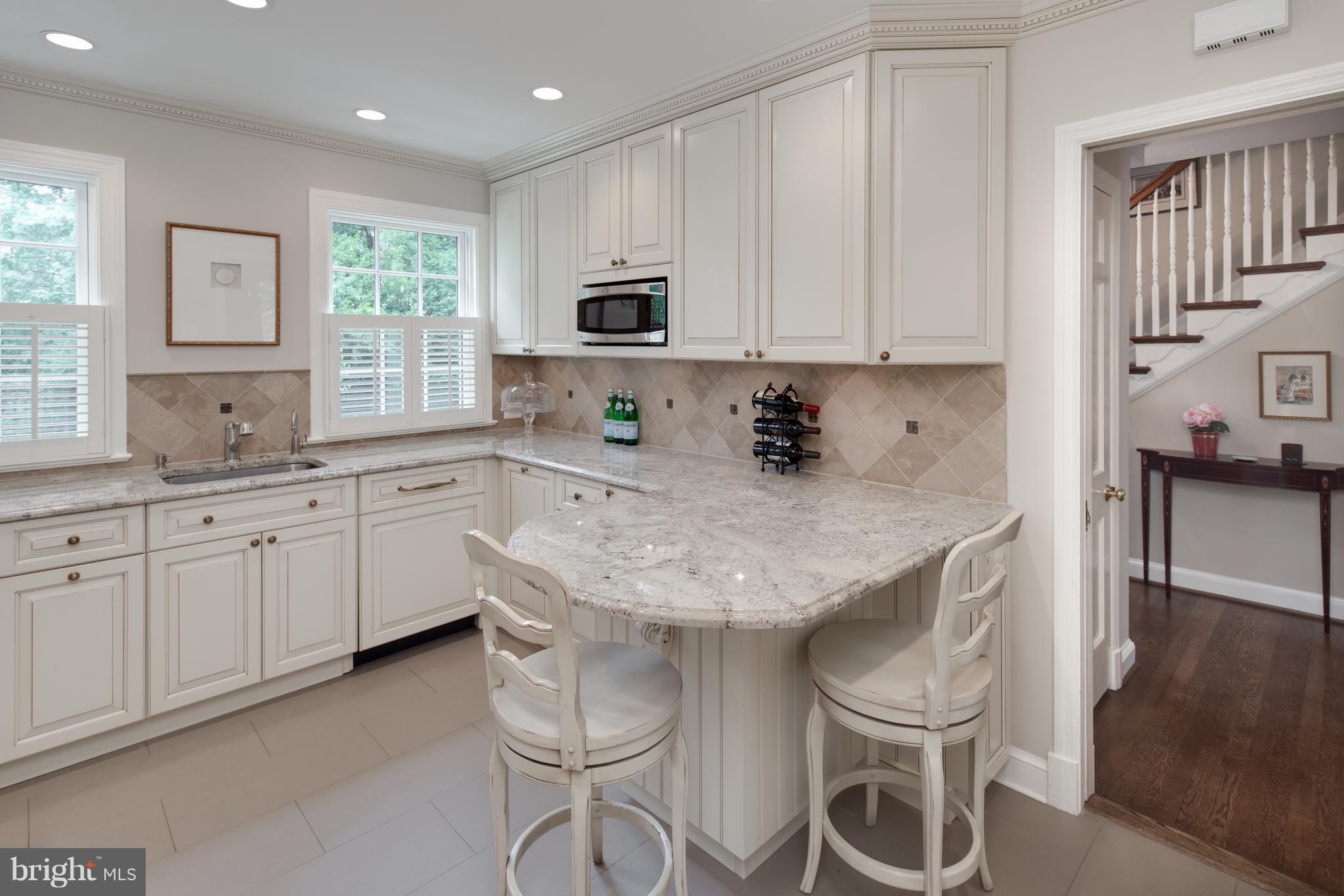 2814 R Street Northwest Washington, DC 20007 - Photo 12 of 30 a kitchen with granite countertop white cabinets and appliances