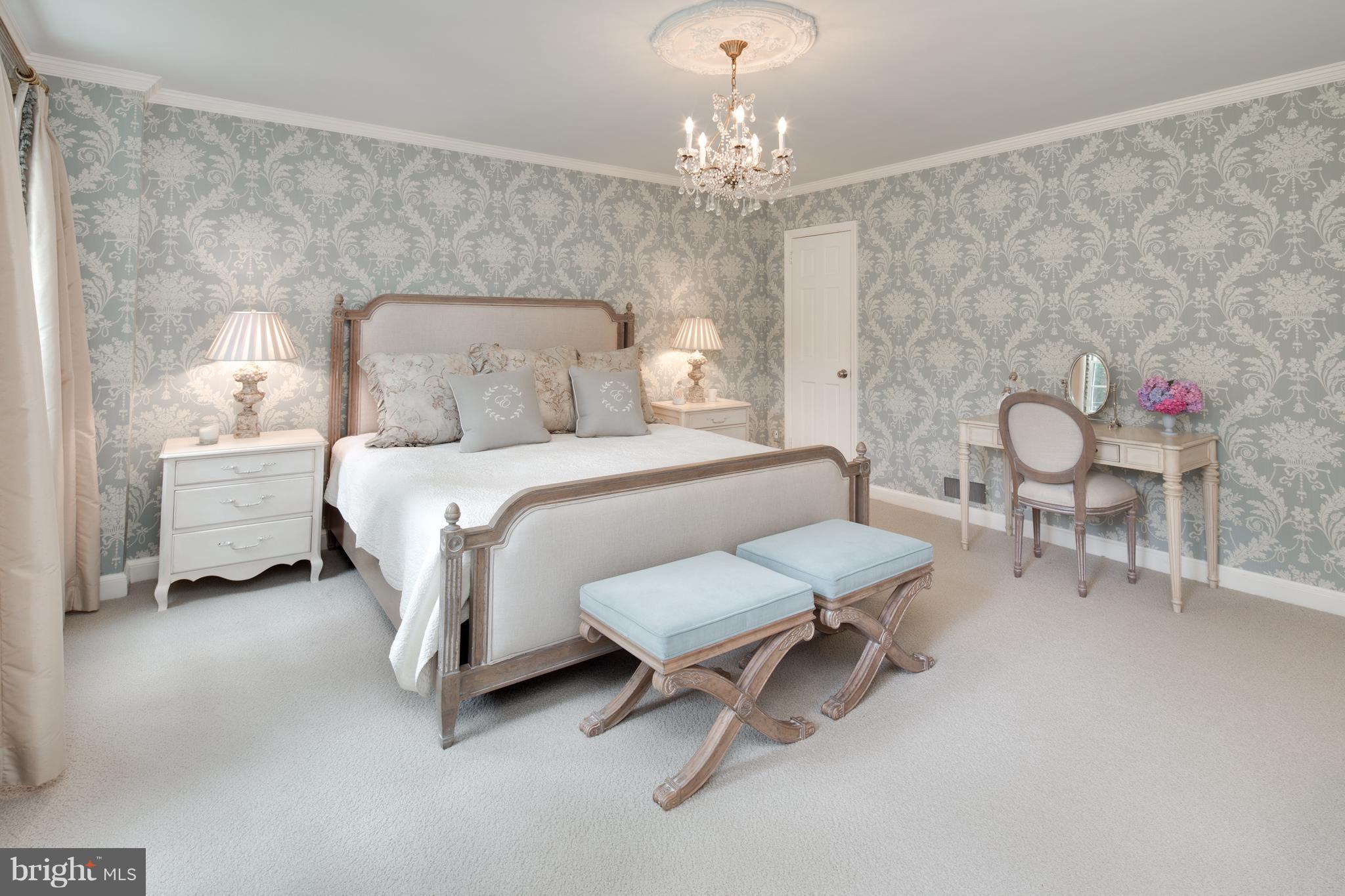 2814 R Street Northwest Washington, DC 20007 - Photo 16 of 30 a spacious bedroom with a bed and a chandelier