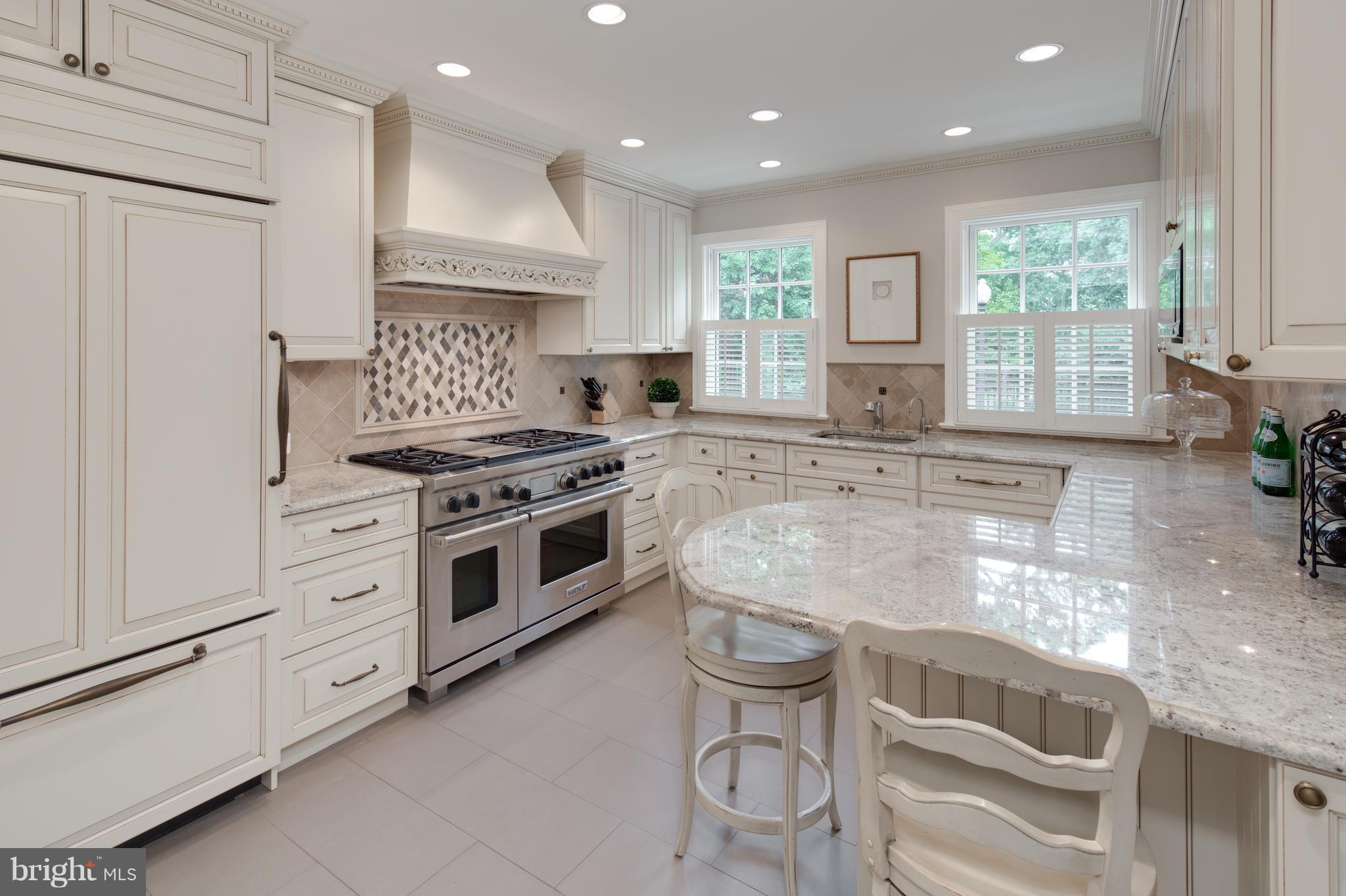 2814 R Street Northwest Washington, DC 20007 - Photo 10 of 30 a kitchen with granite countertop white cabinets and white appliances