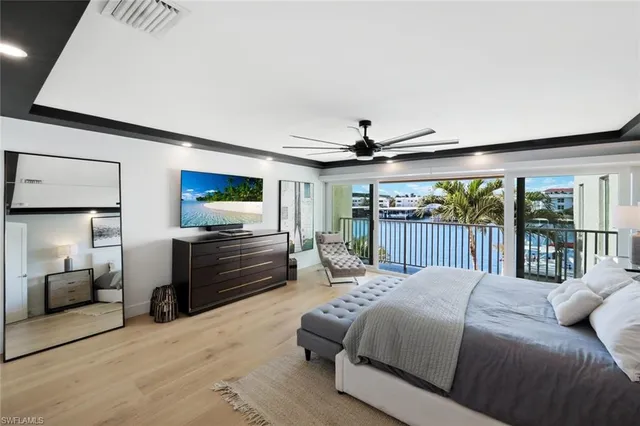 a bedroom with a bed and a large window