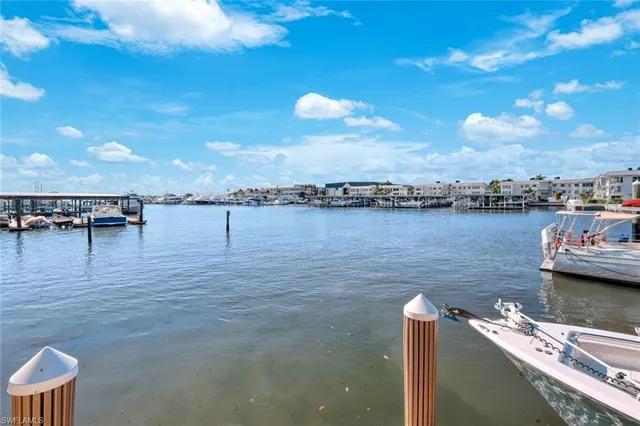a view of a patio with couches chairs and a table with potted plants