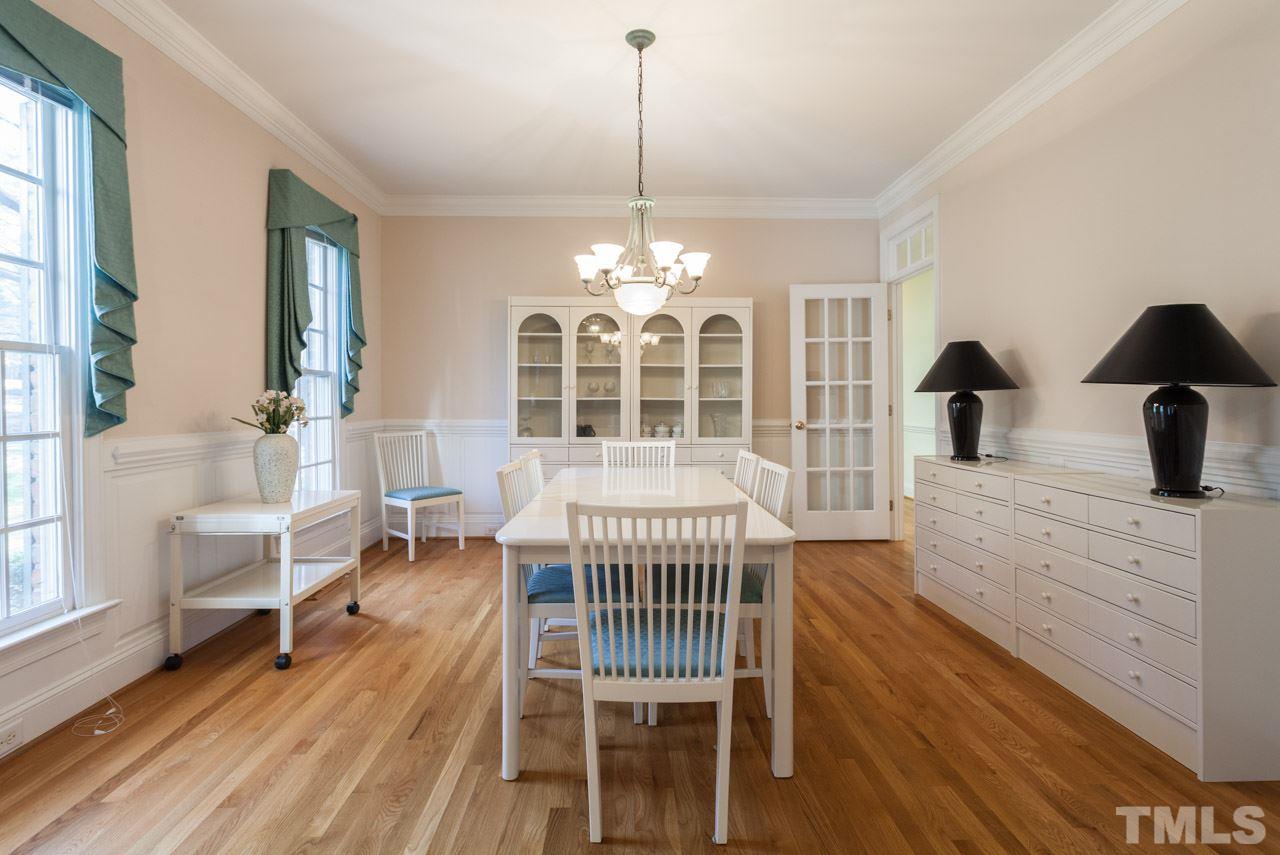 Large Dining Room with wood floors, Crown Molding, custom entry and transom opens you to your butlers pantry and expansive kitchen.