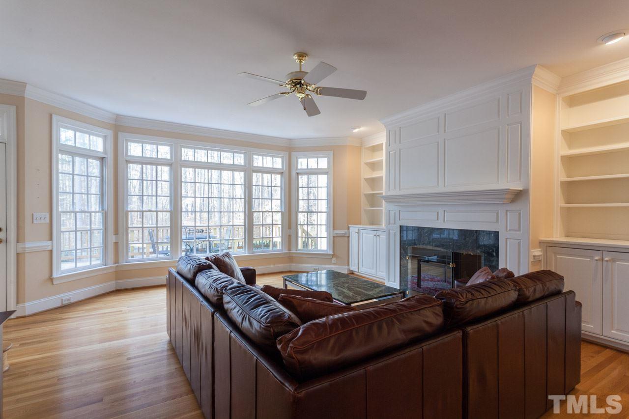 4000 White Chapel Way Raleigh, NC 27615 - Photo 8 of 25 This family room has it all....cozy fireplace, built in bookcases and a stunning view!