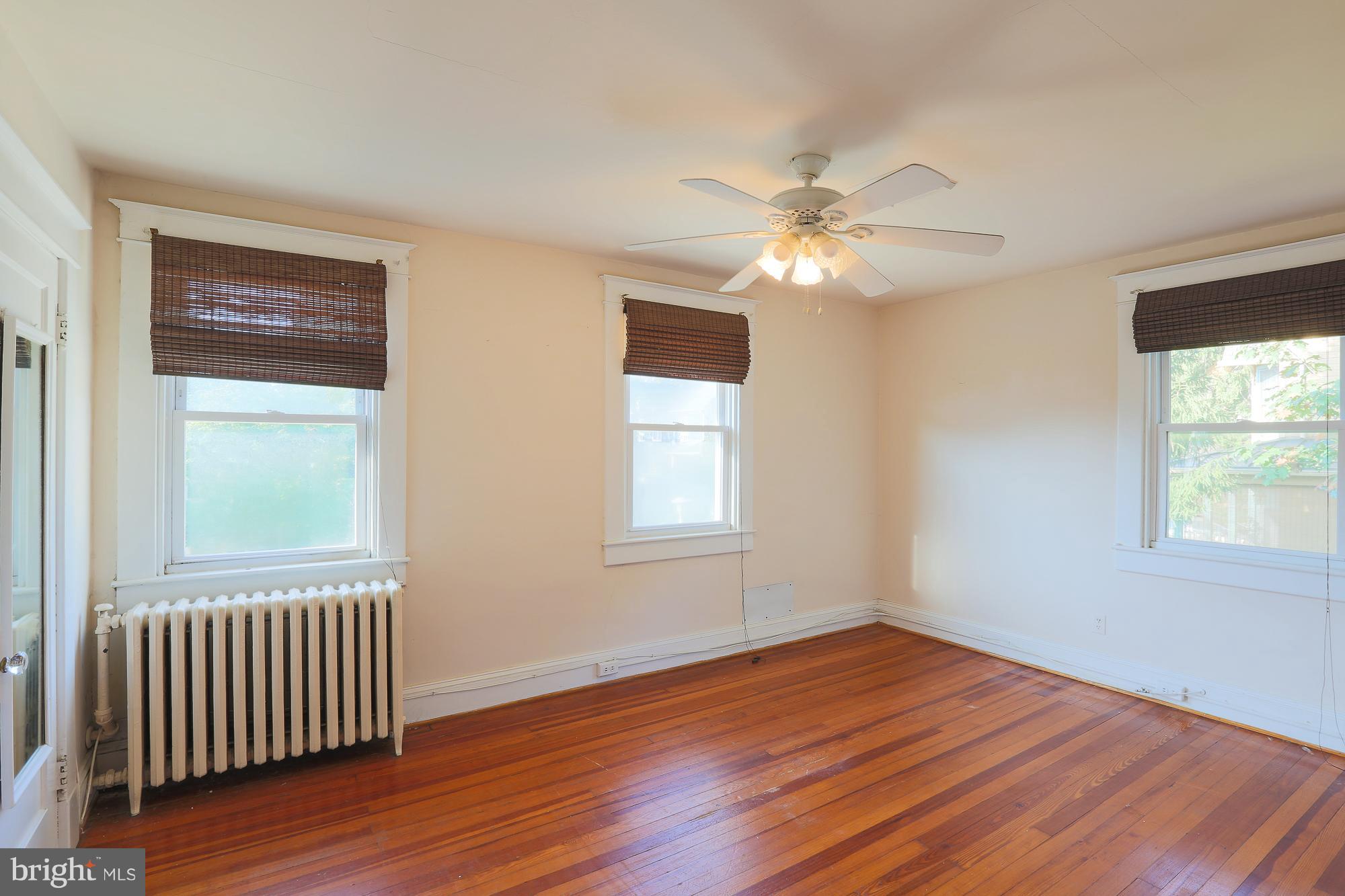 616 St Johns Road Baltimore, MD 21210 - Photo 11 of 15 a view of an empty room with wooden floor and a window