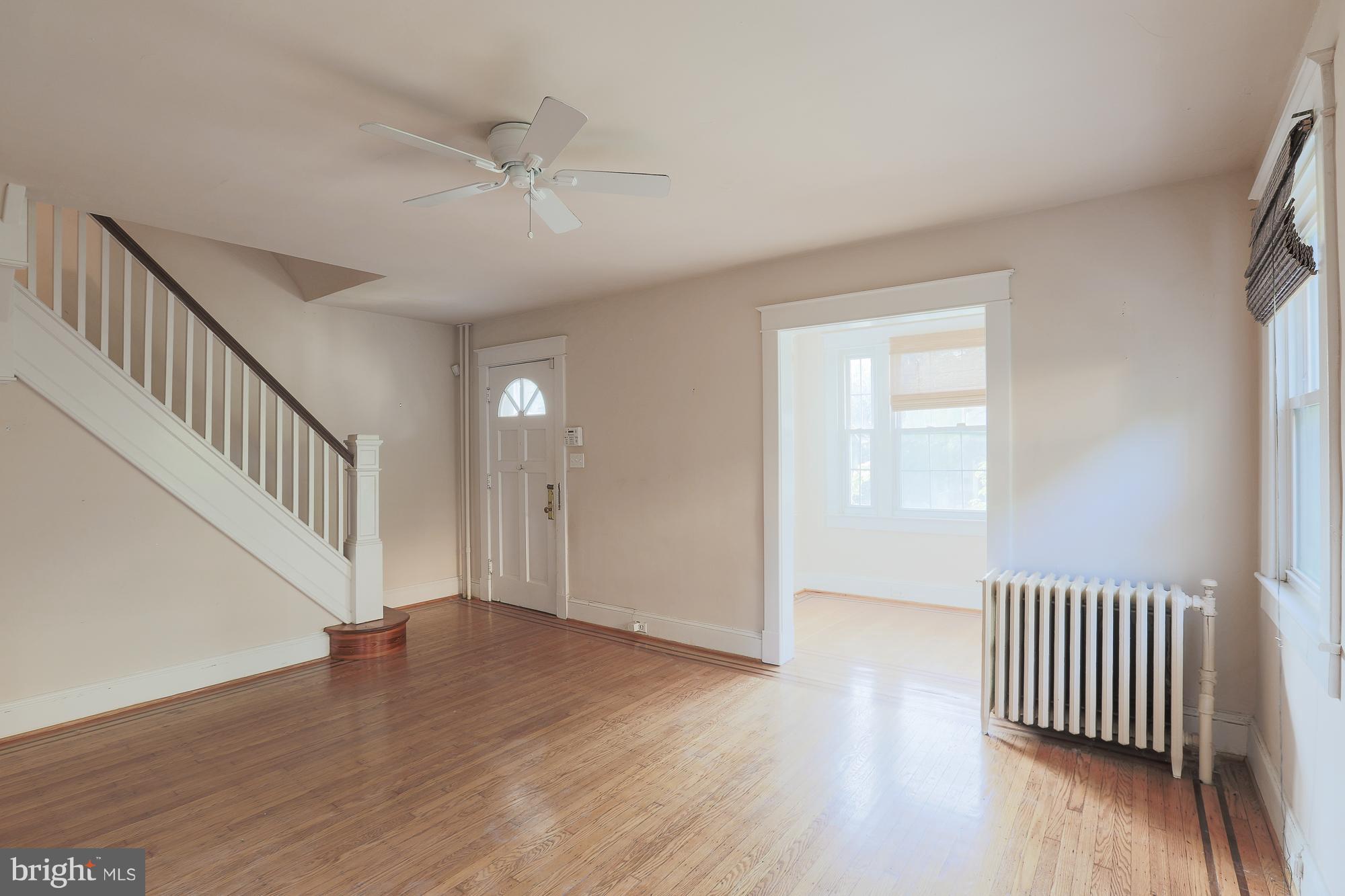 616 St Johns Road Baltimore, MD 21210 - Photo 5 of 15 an empty room with wooden floor and windows