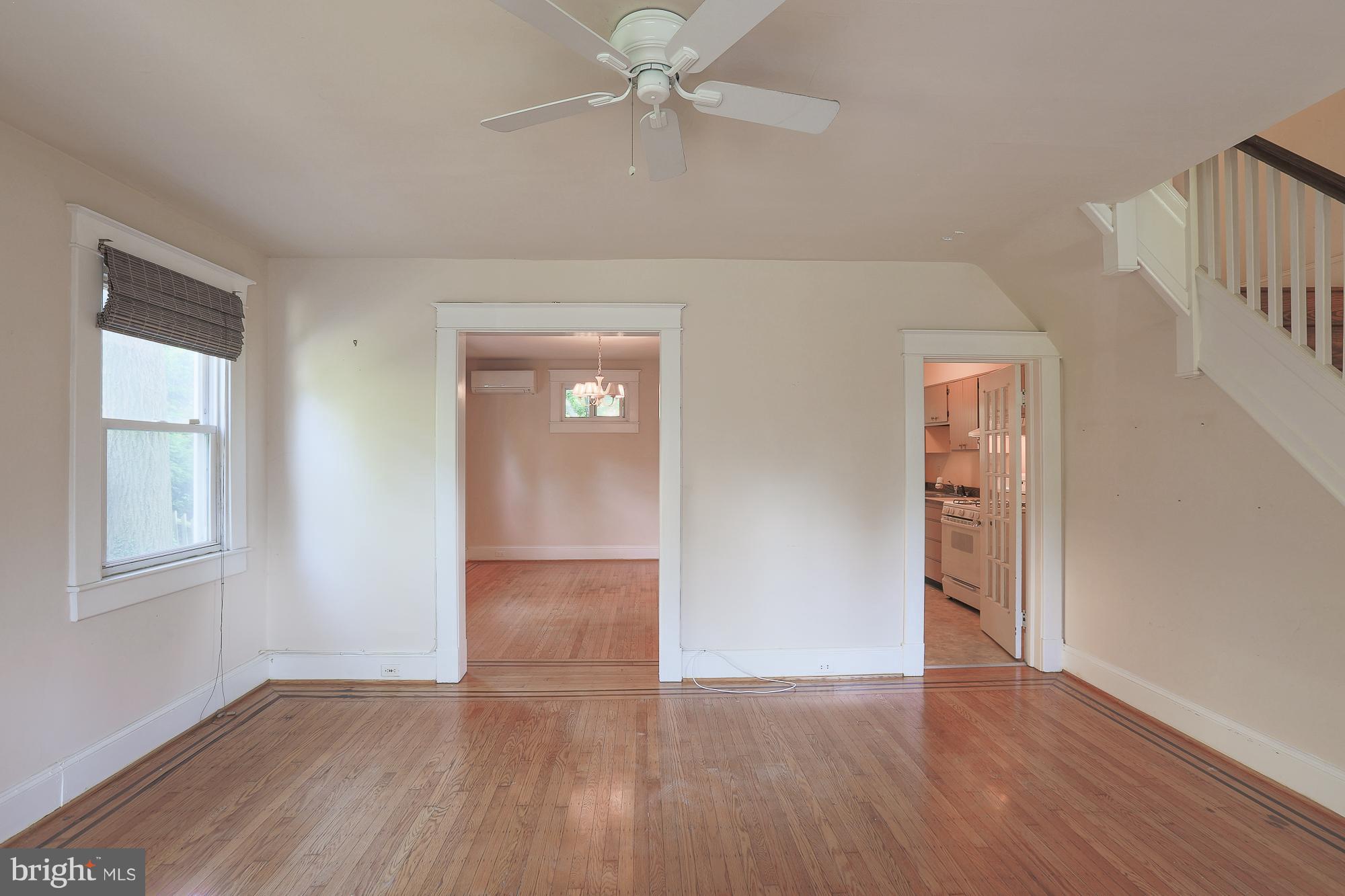 616 St Johns Road Baltimore, MD 21210 - Photo 7 of 15 an empty room with wooden floor and windows