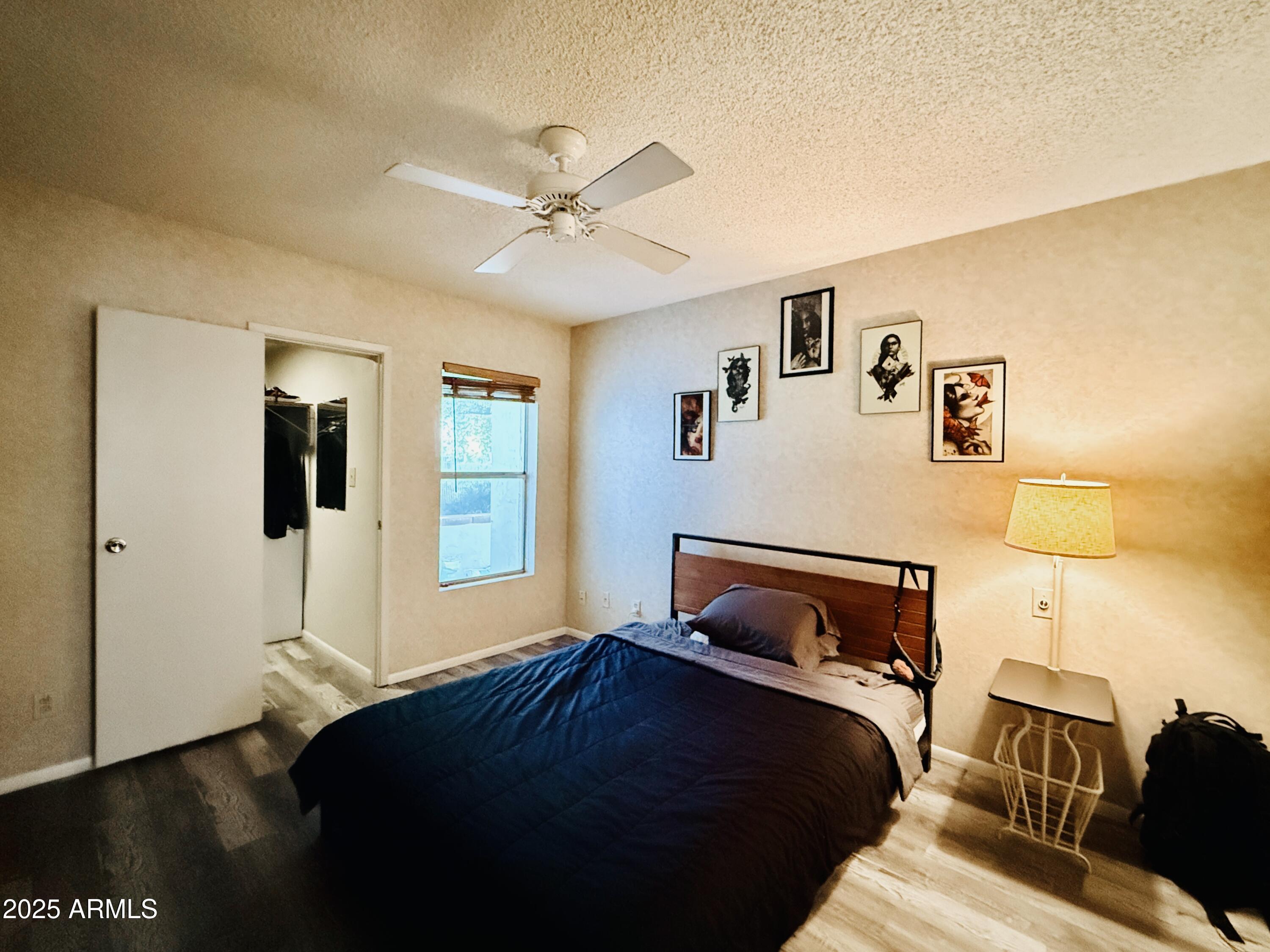 625 South Power Road, Unit 350 Mesa, AZ 85206 - Photo 10 of 20 a bedroom with a bed and wooden floor