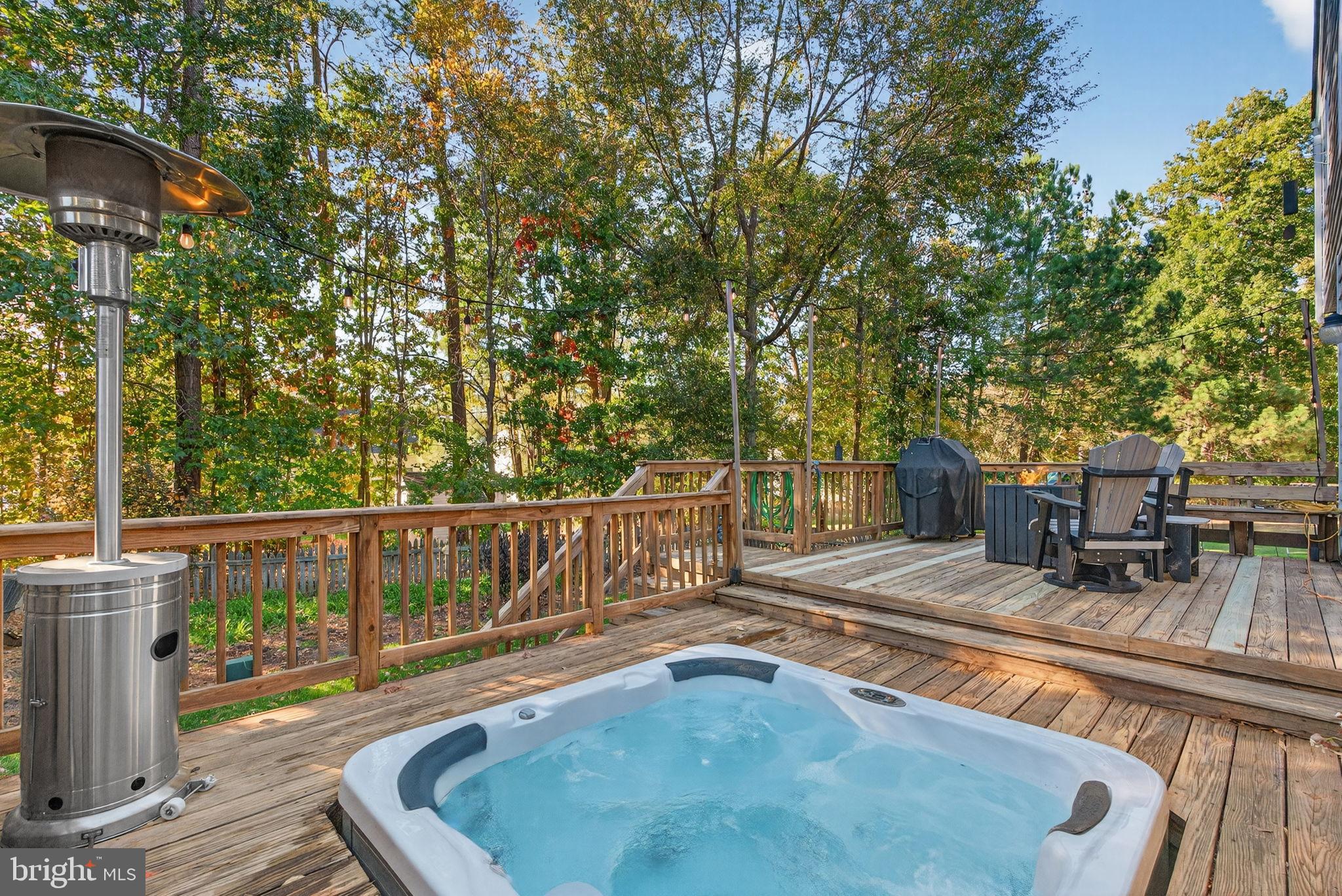 8518 Easton Ridge Place Chesterfield, VA 23832 - Photo 5 of 48 Serene deck with hot tub and lush backdrop.