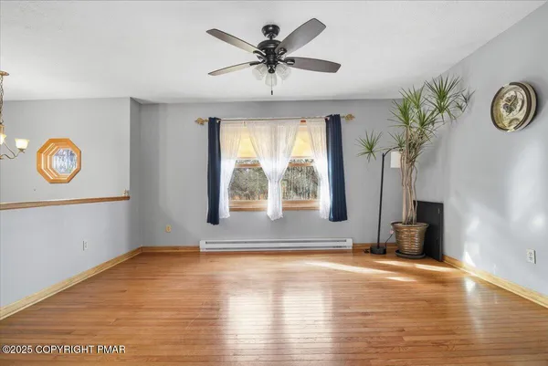 a view of room with window and hardwood floor