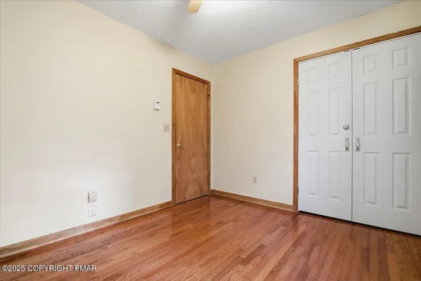 an empty room with wooden floor